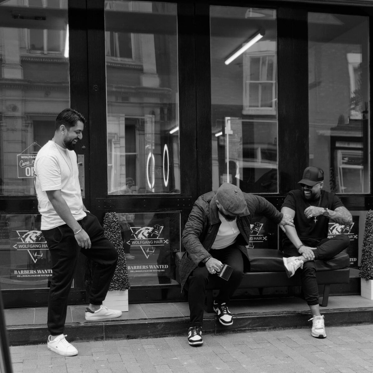 The Wolfgang Hair team sharing a laugh outside the shop